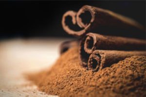 cinnamon sticks and powder on a table