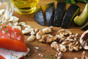 raw fish, nuts, avocado, and other ingredients on a cutting board