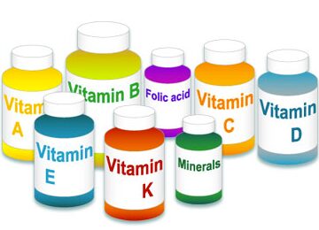a group of vitamin pill bottles filled with different colors