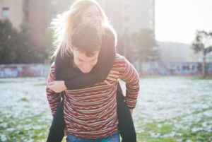 a man carrying a woman on his back