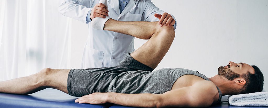 a man getting his leg examined by a doctor