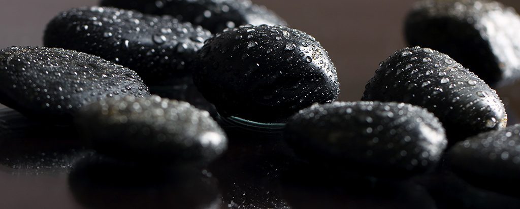 some black fruits are sitting on a table