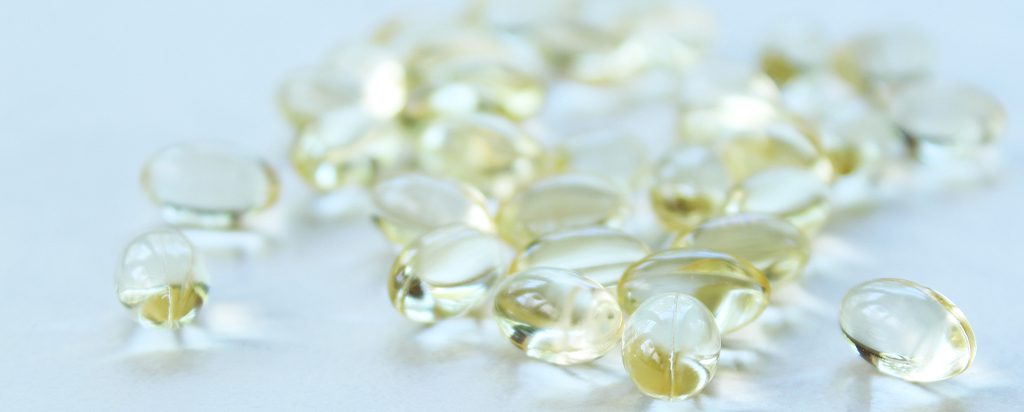 a bunch of yellow glass beads on a white surface