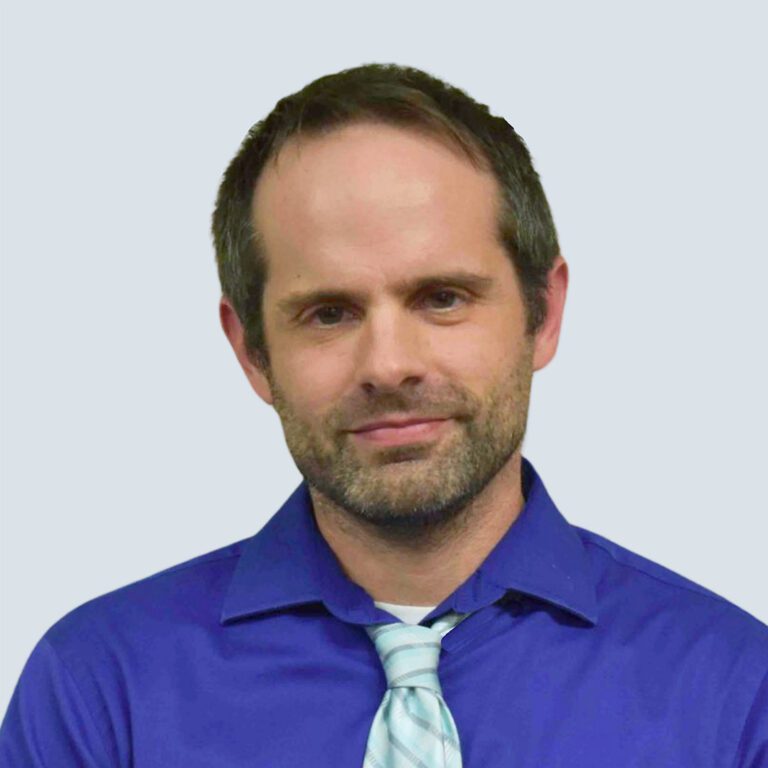 a man wearing a blue shirt and tie