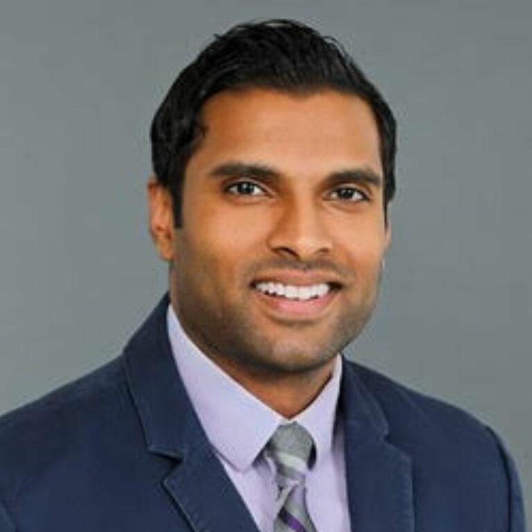 a man in a suit and tie smiling