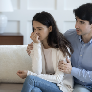 a man and woman are sitting on a couch