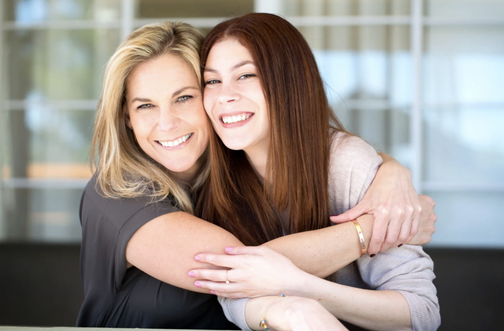 mom and daughter hugging