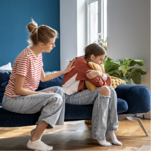 a woman sitting on a couch with a child